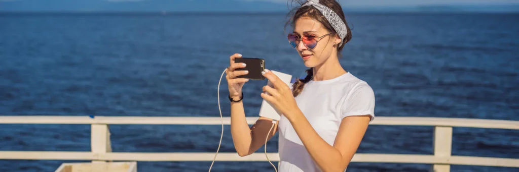 Femme de bateau de croisière utilisant un téléphone portable en vacances à l'océan